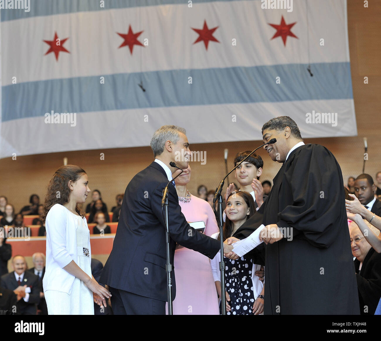 Rahm Emanuel (second left), accompanied by his daughter Ilana (L-R), wife Amy Rule, daughter Leah and son Zach, shakes hands with Cook County Circuit Court Judge Timothy Evans (R) after taking the oath of office during an inaugural ceremony at Millennium Park on May 16, 2011. Emanuel takes over for Richard M. Daley, who had served in the post since 1989.     UPI/Brian Kersey Stock Photo
