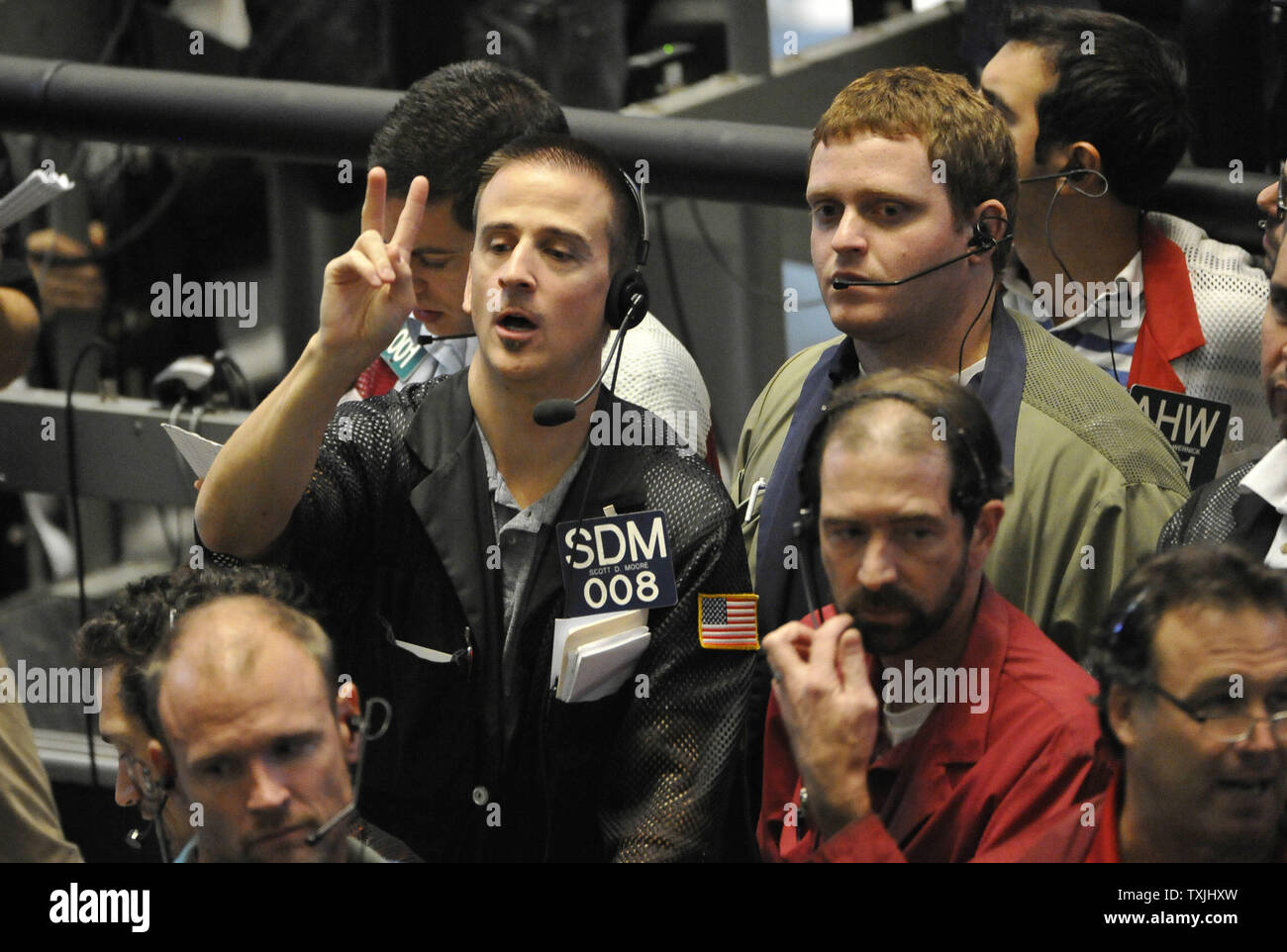 Scott Moore (L) works in the Eurodollar futures pit on the trading floor at  the CME Group on September 21, 2011 in Chicago. The Federal Reserve Open  Market Committee announced Wednesday that