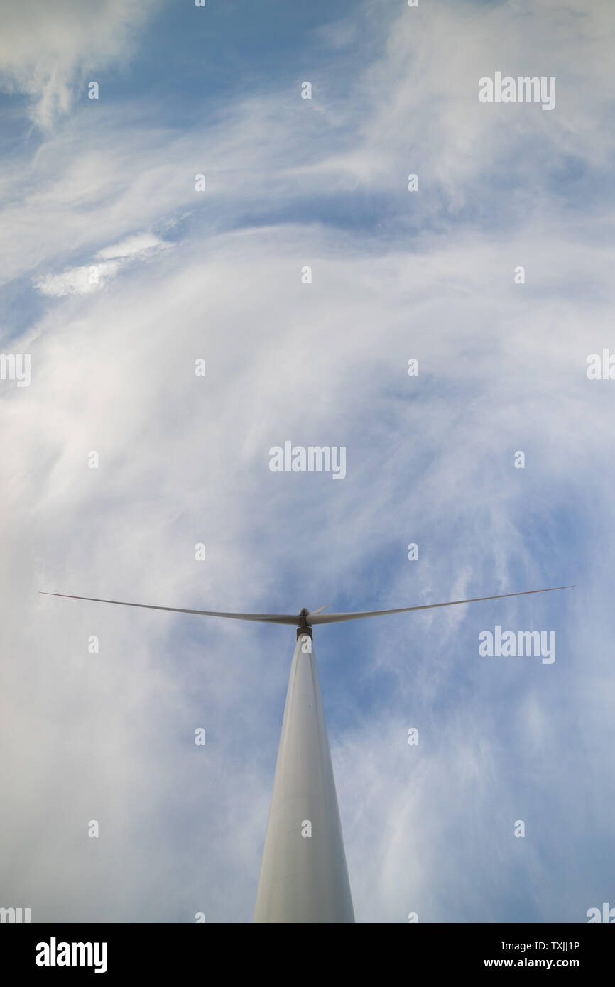 One wind turbine with cloudy sky in background Stock Photo - Alamy