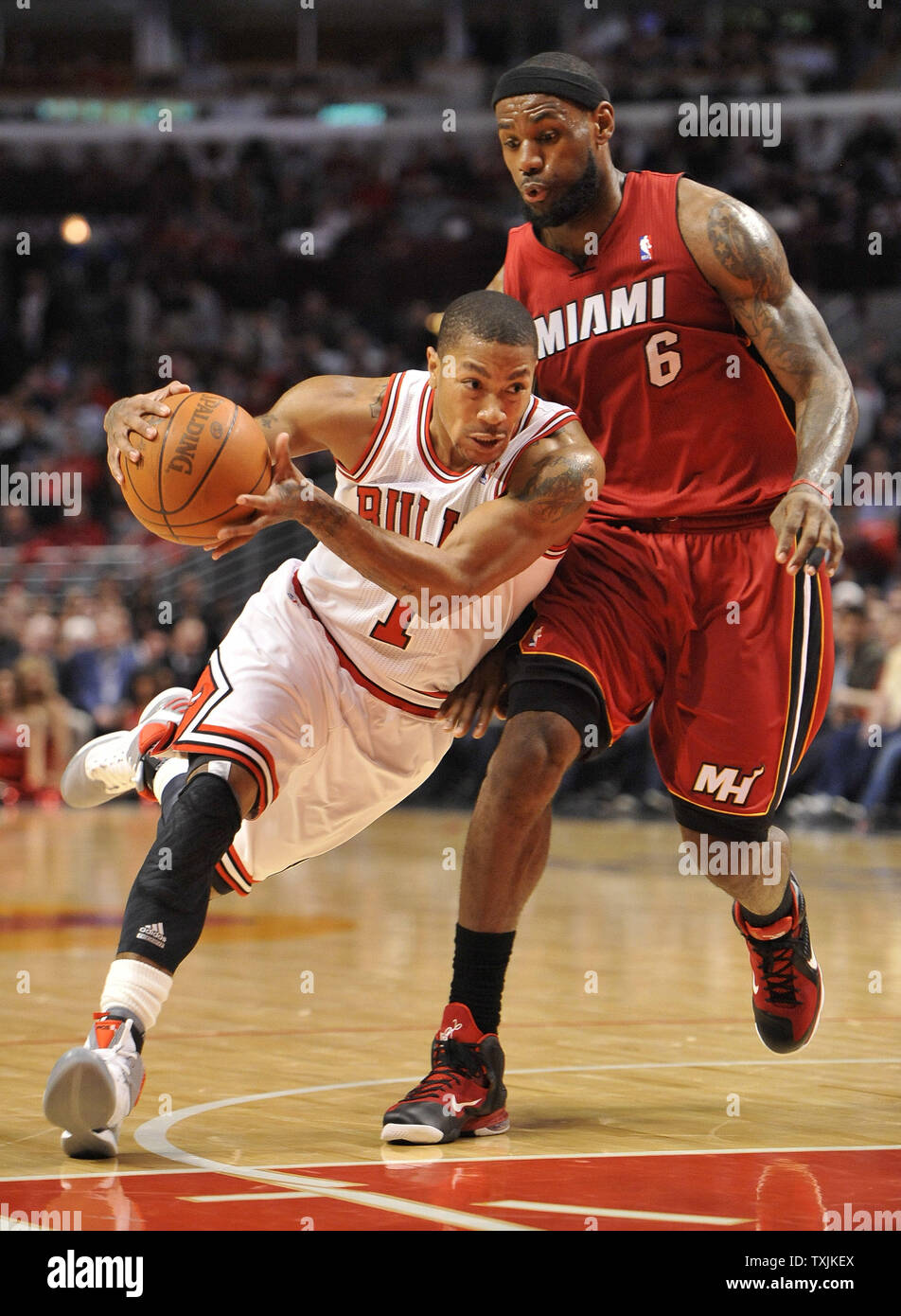 Chicago Bulls guard Derrick Rose L drives past Miami Heat forward LeBron James during the third quarter at the United Center on April 12 2012 in Chicago. UPI Brian Kersey Stock Photo Alamy