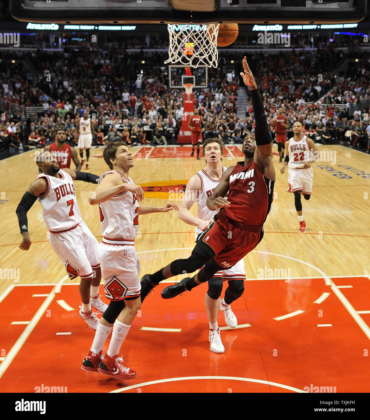Miami Heat shooting guard Dwyane Wade (R) goes up for a layup as Chicago Bulls guard C.J. Watson (L-R), forward Kyle Korver and center Omer Asik of Turkey defend during the second half at the United Center on April 12, 2012 in Chicago. The Bulls won 96-86 in overtime.     UPI/Brian Kersey Stock Photo