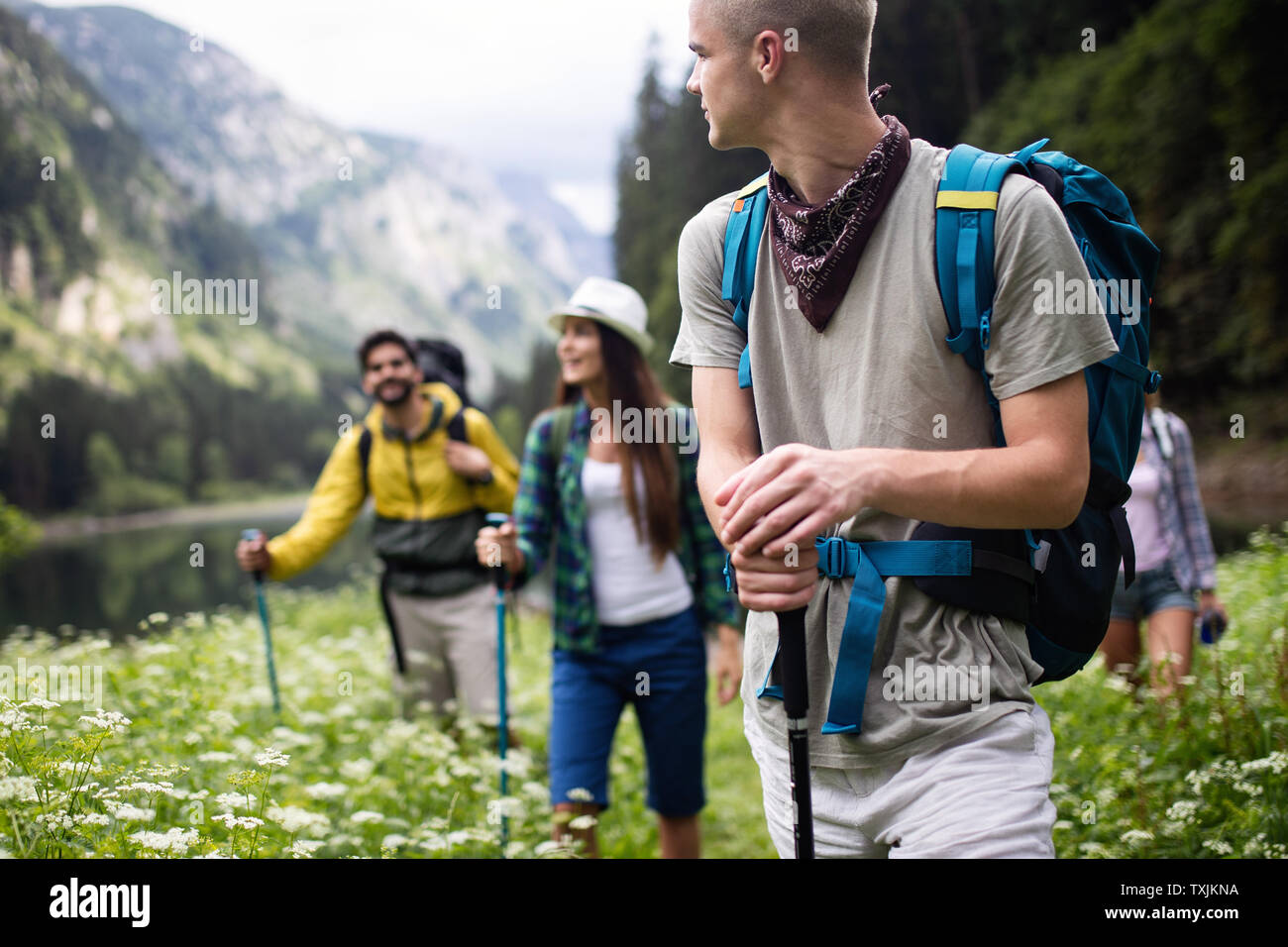 Group of friends hikers walking on a mountain at sunset Stock Photo - Alamy