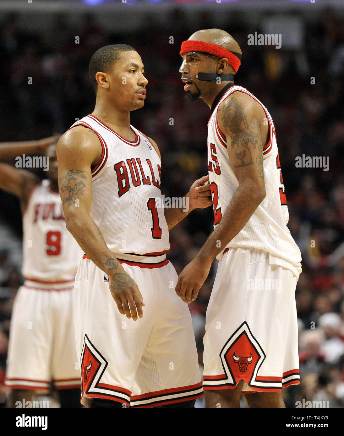 Chicago Bulls guard Derrick Rose (L) talks with guard Richard Hamilton  during the third quarter of game 1 of the first round of the Eastern  Conference Playoffs at the United Center on