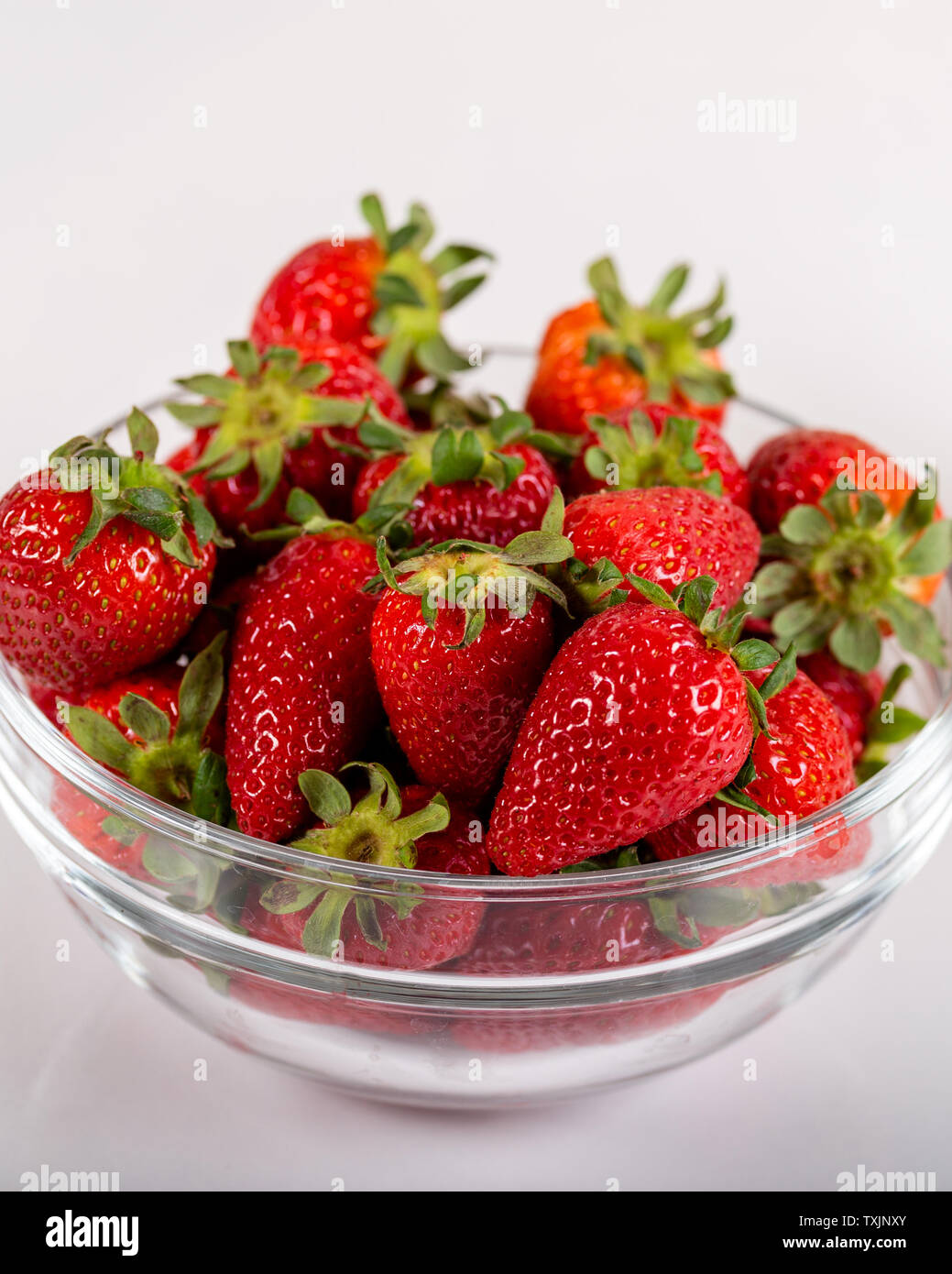 Fresh strawberries in a glass bowl and a glass of strawberry milk Stock ...