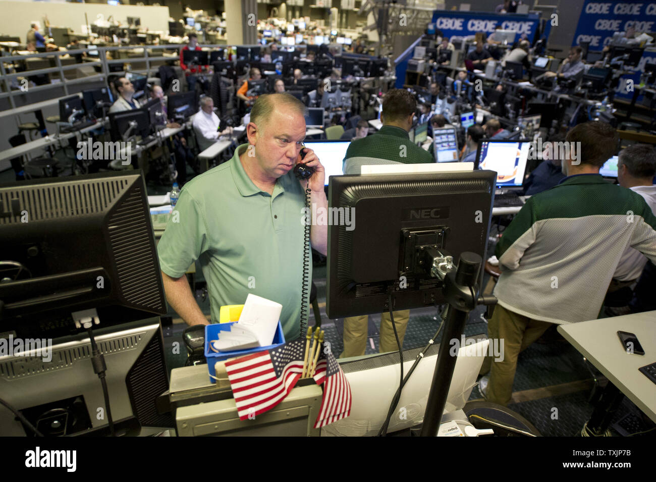 A trader talks on the phone in the CBOE Volatility Index (VIX) pit at the Chicago Board Options Exchange on December 12, 2012 in Chicago. Stocks were rising after the Federal Reserve Open Market Committee announced it will keep the Fed Funds interest rate near zero until the 7.8 percent unemployment drops to 6.5 percent inflation increases to 2.5 percent from its current 2.2 percent rate. The FOMC also announced that it will purchase $45 billion a month in Treasury bonds and continue to buy $45 billion a month in mortgage-backed bonds to stimulate the economy.       UPI/Brian Kersey Stock Photo