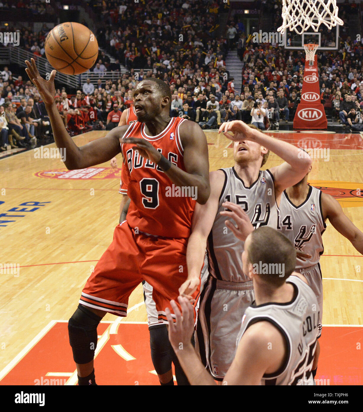 https://c8.alamy.com/comp/TXJPH6/chicago-bulls-small-forward-luol-deng-grabs-a-rebound-from-san-antonio-spurs-power-forward-matt-bonner-l-during-the-first-half-at-the-united-center-in-chicago-on-february-11-2013-upibrian-kersey-TXJPH6.jpg