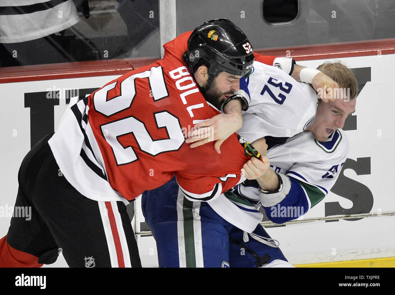 Chicago Blackhawks left wing Brandon Bollig (L) and Vancouver Canucks right wing Dale Weise fight during the first period at the United Center in Chicago on February 19, 2013.     UPI/Brian Kersey Stock Photo