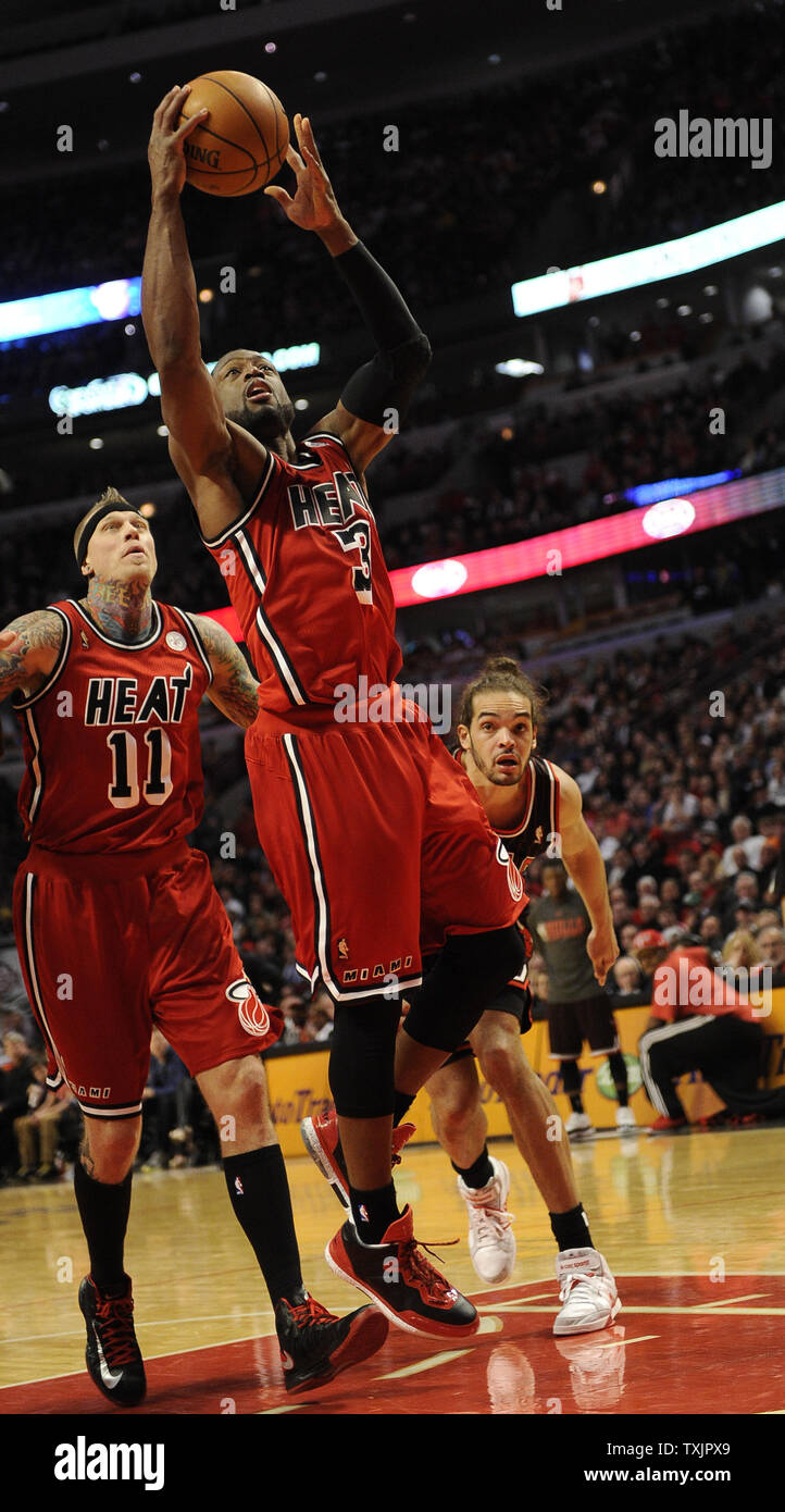 Miami Heat shooting guard Dwyane Wade (3) soots past Chicago Bulls center Joakim Noah (13) during the second half at the United Center in Chicago on February 21, 2013.     UPI/David Banks Stock Photo