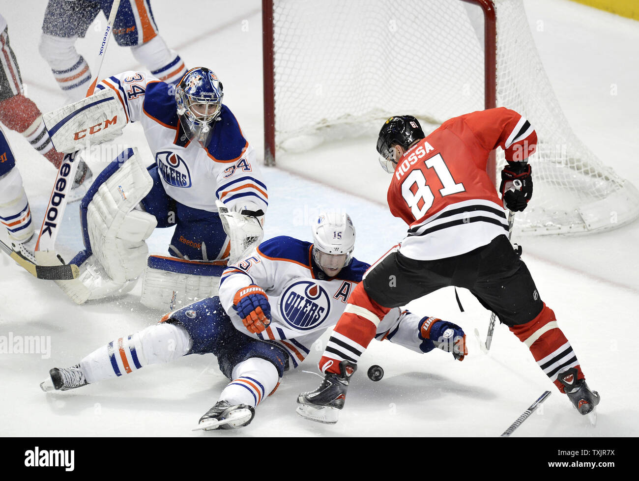 Edmonton Oilers defenseman Nick Schultz (C) and goalie Yann Danis (L) defend the goal as Chicago Blackhawks right wing Marian Hossa tries to score during the third period at the United Center in Chicago on March 10, 2013. The Oilers won 6-5.      UPI/Brian Kersey Stock Photo