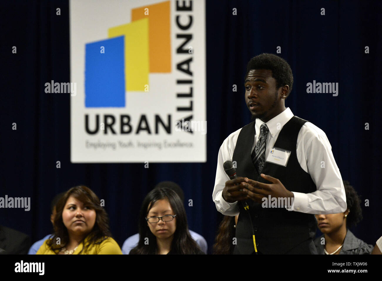 Steven O'Neal Jr., a student involved with Urban Alliance, tells First Lady Michelle Obama, Chicago Mayor Rahm Emanuel and Chicago First Lady Amy Rule about his experiences in the program at Columbia College in Chicago on July 18, 2013. With her visit, the First Lady seeks to bring attention to programs like Urban Alliance which is a year-long career education and employment program for underserved high school seniors that provides paid internships, formal training, and mentoring.     UPI/Brian Kersey Stock Photo