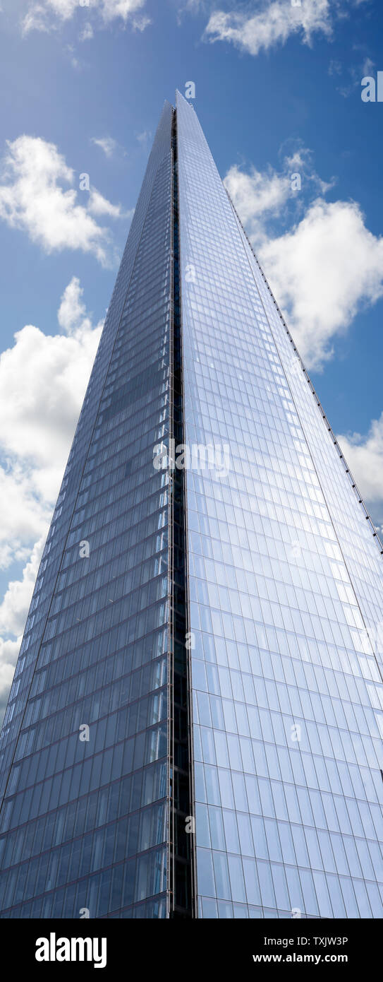 shard skyscraper looming high into the beautiful blue cloudy sky Stock Photo