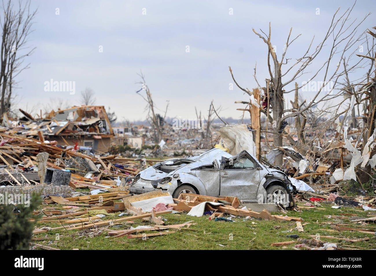 A car sits in the middle of a devastated subdivision in Washington, Illinois on November 18, 2013. Six people died and hundreds of homes were destroyed in Illinois as 81 tornadoes were sighted on November 17 throughout 12 midwest states including the EF4 tornado that struck Washington, Illinois.     UPI/Brian Kersey Stock Photo