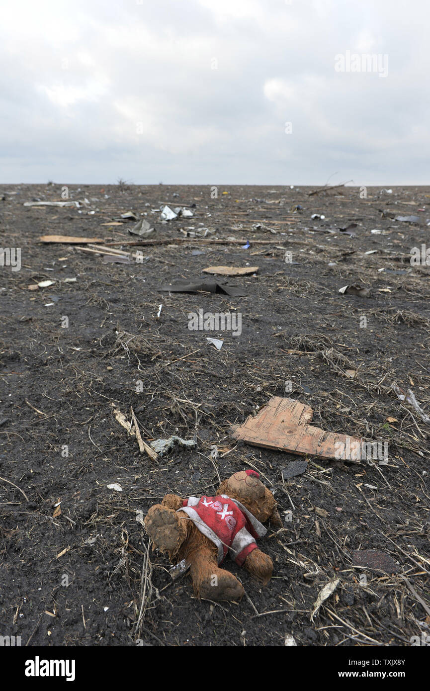 A stuffed animal lies in a cornfield in Washington, Illinois on November 18, 2013. Washington was struck by an EF4 tornado on Sunday. Six people died and hundreds of homes were destroyed in Illinois as 81 tornadoes were sighted on November 17 throughout 12 midwest states.     UPI/Brian Kersey Stock Photo