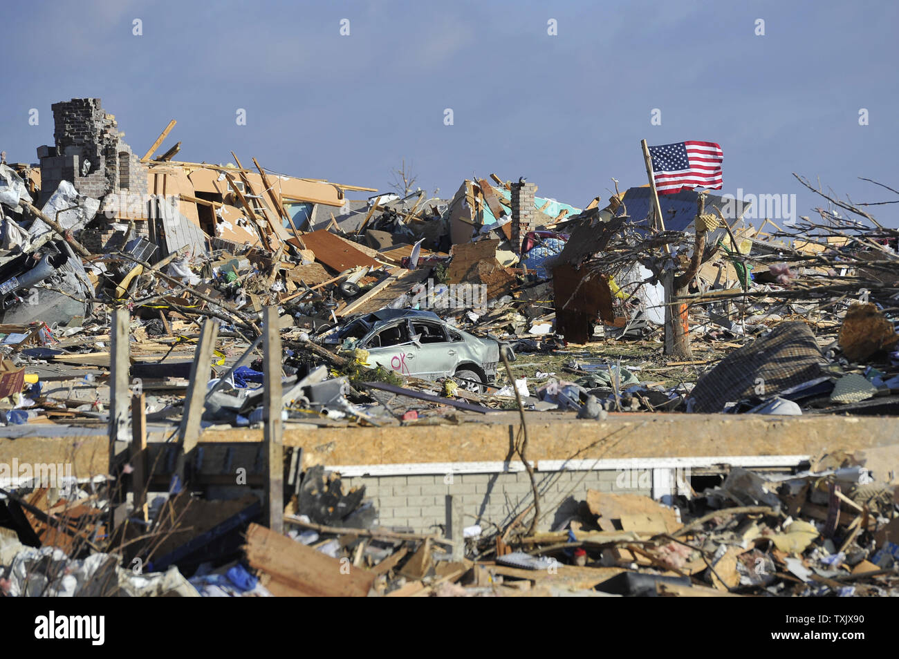 An American flag flies amid the devastation in Washington, Illinois on November 18, 2013. Six people died and hundreds of homes were destroyed in Illinois as 81 tornadoes were sighted on November 17 throughout 12 midwest states including the EF4 tornado that struck Washington, Illinois.     UPI/Brian Kersey Stock Photo