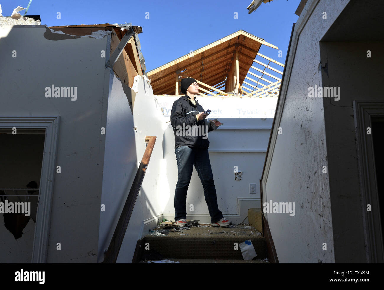 Helen Potts surveys the damage to her home in Washington, Illinois on November 18, 2013. Six people died and hundreds of homes were destroyed in Illinois as 81 tornadoes were sighted on November 17 throughout 12 midwest states including the EF4 tornado that struck Washington, Illinois.     UPI/Brian Kersey.     UPI/Brian Kersey Stock Photo