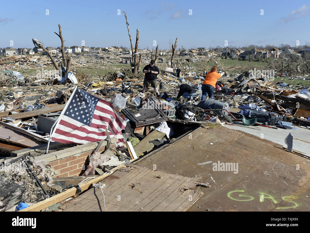 Residents sort through the rubble after their home was destroyed in Washington, Illinois on November 18, 2013. Six people died and hundreds of homes were destroyed in Illinois as 81 tornadoes were sighted on November 17 throughout 12 midwest states including the EF4 tornado that struck Washington, Illinois.     UPI/Brian Kersey.     UPI/Brian Kersey Stock Photo