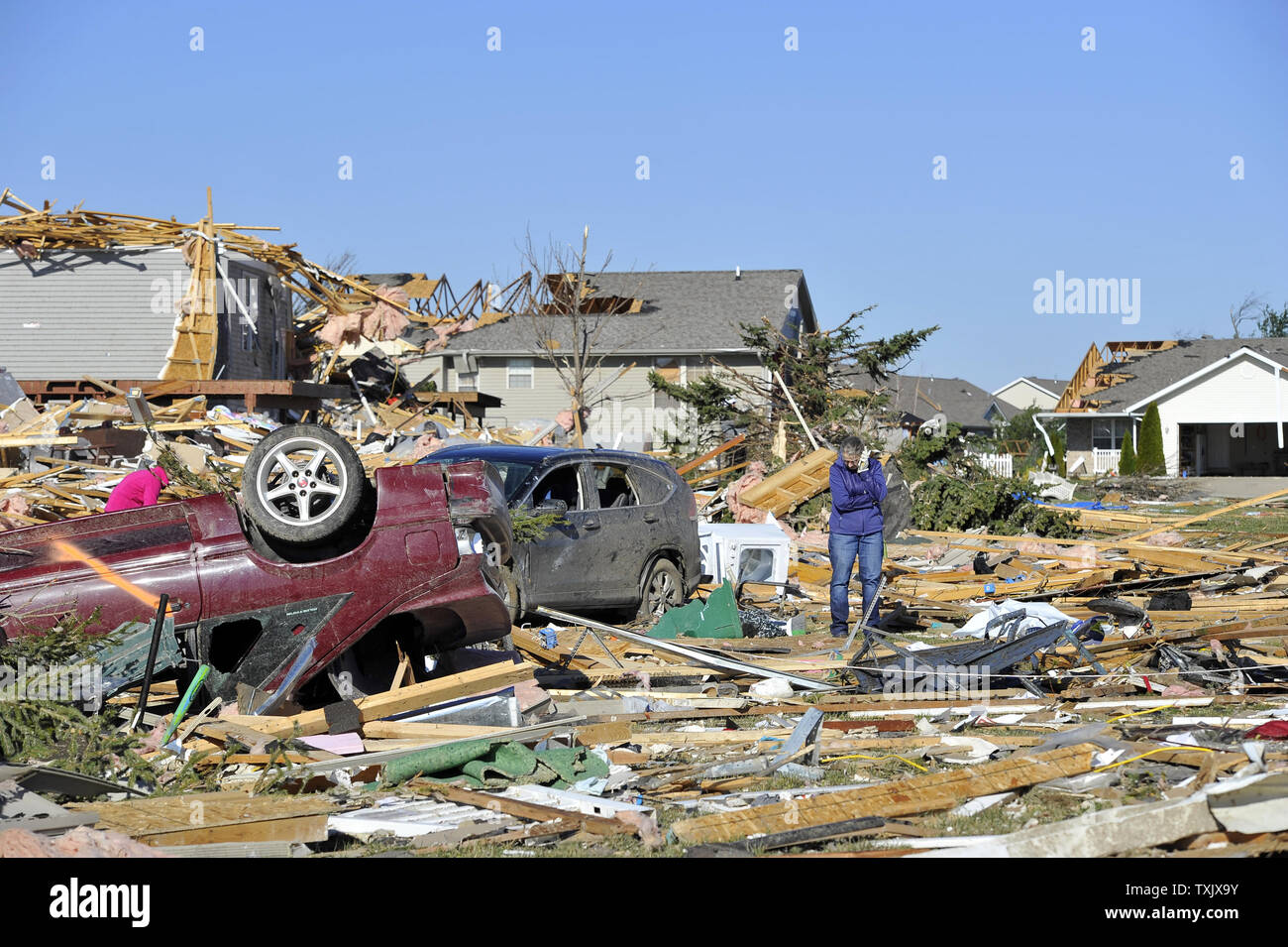 A resident sorts through the devastation in Washington, Illinois on November 18, 2013. Six people died and hundreds of homes were destroyed in Illinois as 81 tornadoes were sighted on November 17 throughout 12 midwest states including the EF4 tornado that struck Washington, Illinois.     UPI/Brian Kersey.     UPI/Brian Kersey Stock Photo
