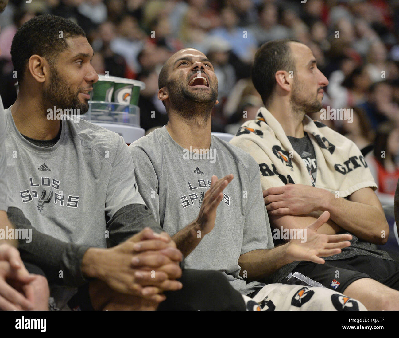 San Antonio Spurs guard Tony Parker (C) laughs as he sits on the bench with forward Tim Duncan (L) and guard Manu Ginobili during the fourth quarter against the Chicago Bulls at the United Center in Chicago on March 11, 2014. The Spurs defeated the Bulls 104-96.     UPI/Brian Kersey Stock Photo