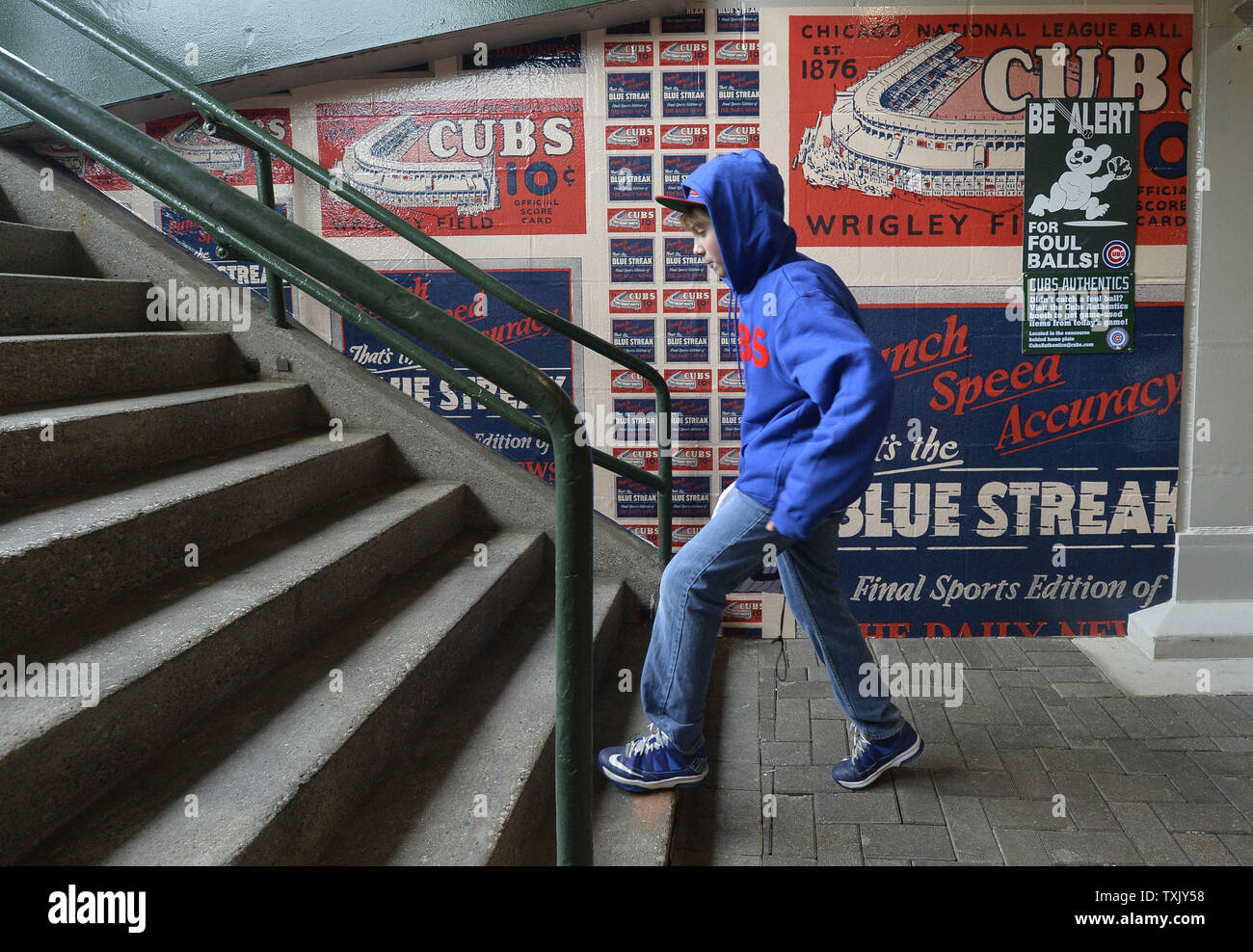 Dylan Kuhl, 12, walks past a mural depicting an old Chicago Daily News