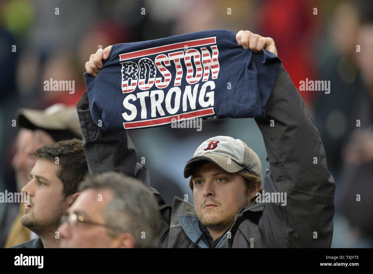 A fan holds up a Boston Strong tee shirt during a moment of silence,  honoring the victims of last year's Boston Marathon bombing, before the Boston  Red Sox game against the Chicago