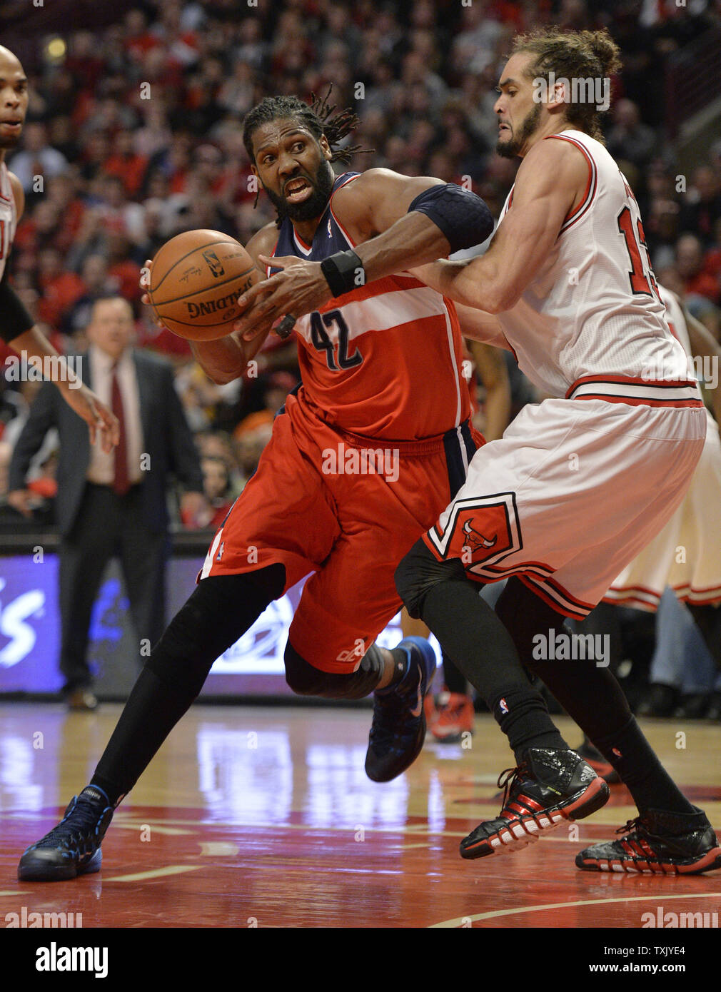 Washington Wizards forward Nene Hilario (L) drives on Chicago Bulls center Joakim Noah during the fourth quarter of Game 2 of the NBA Eastern Conference quarterfinals at the United Center on April 22, 2014 in Chicago. The Wizards defeated the Bulls 101-99 in overtime and lead the best of seven series 2-0.     UPI/Brian Kersey Stock Photo