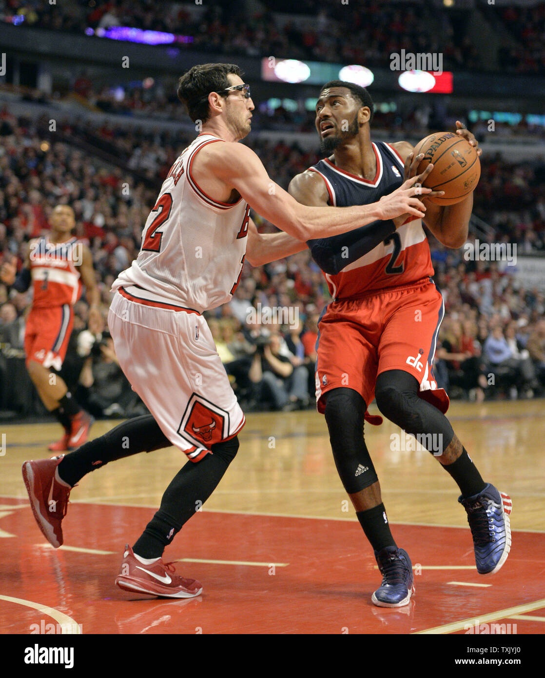 Chicago Bulls guard Kirk Hinrich (L) fouls Washington Wizards guard John  Wall as he drives to the basket during the third quarter of Game 5 of the  NBA Eastern Conference quarterfinals at