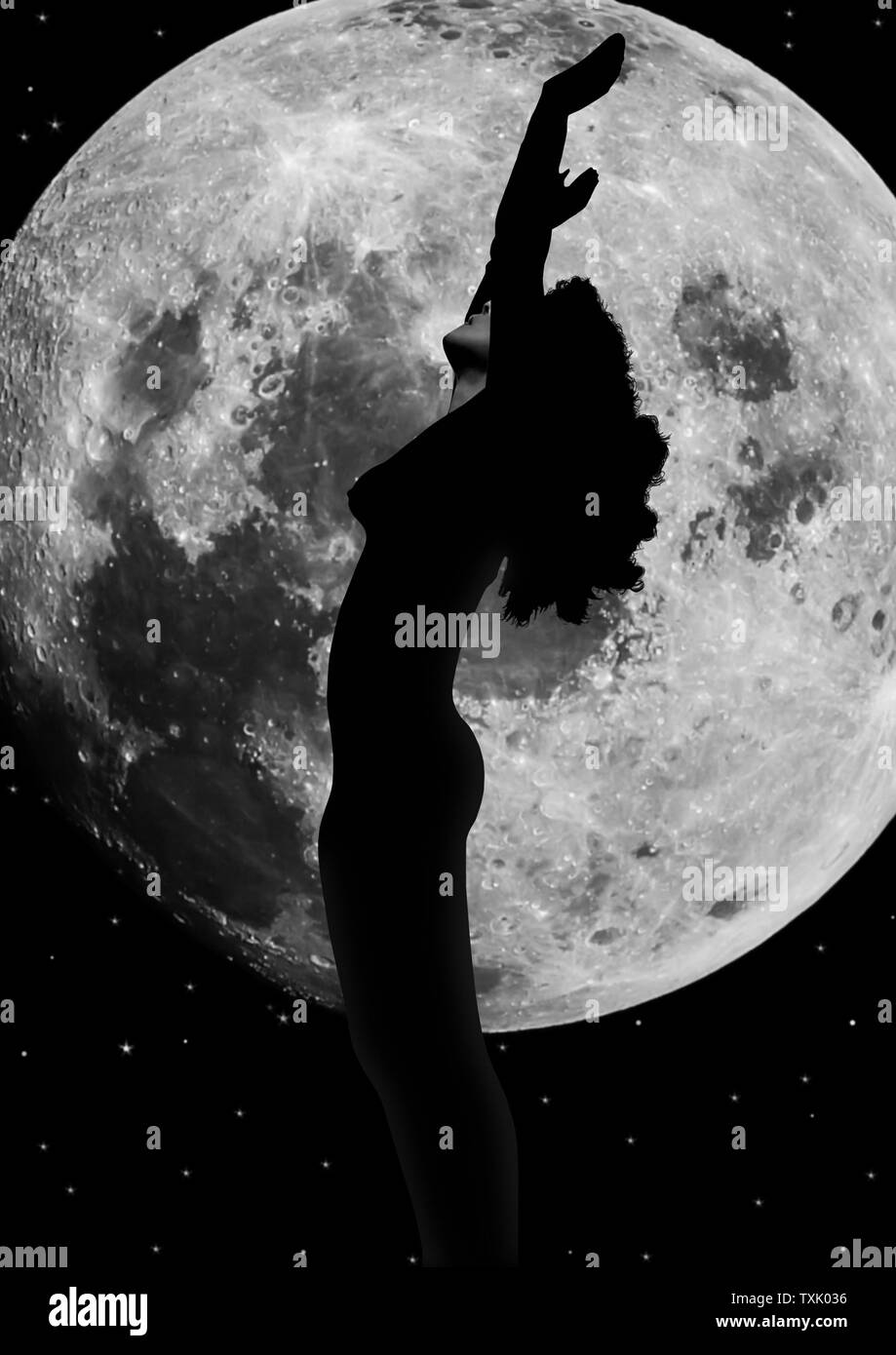 attractive silhouetted nude woman holding her hands up to the moon giving gratitude to the heavens in a yoga pose with a cloudy background Stock Photo