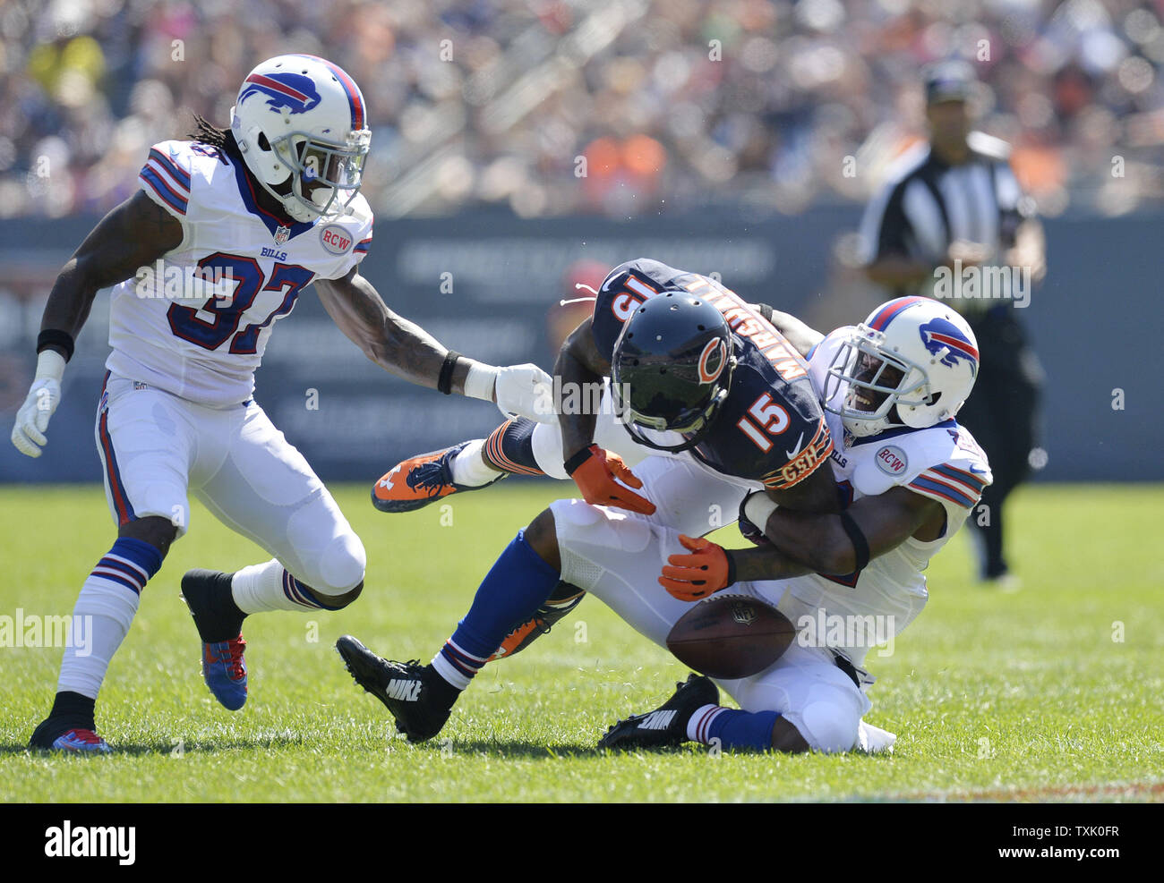 Buffalo Bills cornerback Leodis McKelvin (R) strips the ball from Chicago Bears wide receiver Brandon Marshall (C) as defensive back Nickell Robey helps out during the second quarter at Soldier Field on September 7, 2014 in Chicago. The Bills recovered the fumble.     UPI/Brian Kersey Stock Photo