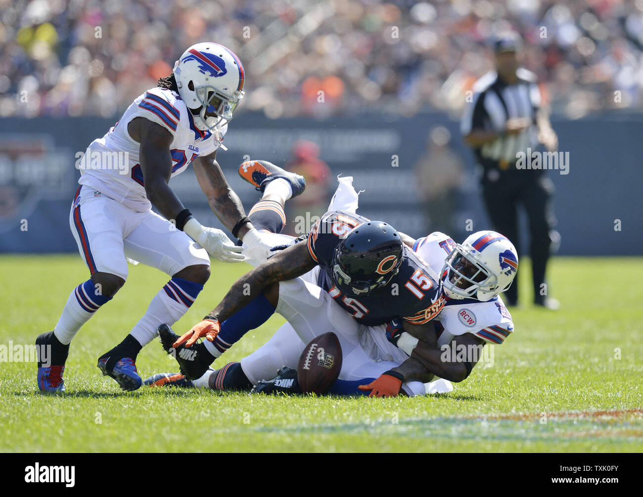Buffalo Bills cornerback Leodis McKelvin (R) strips the ball from Chicago Bears wide receiver Brandon Marshall (C) as defensive back Nickell Robey helps out during the second quarter at Soldier Field on September 7, 2014 in Chicago. The Bills recovered the fumble.     UPI/Brian Kersey Stock Photo
