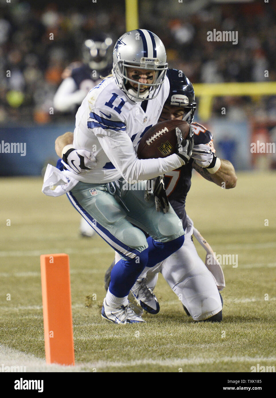 New England Patriots offensive tackle Quinn Ojinnaka (L) pats running back  Danny Woodhead on the head after Woodhead scored on a 3-yard touchdown run  during the second quarter at Soldier Field in