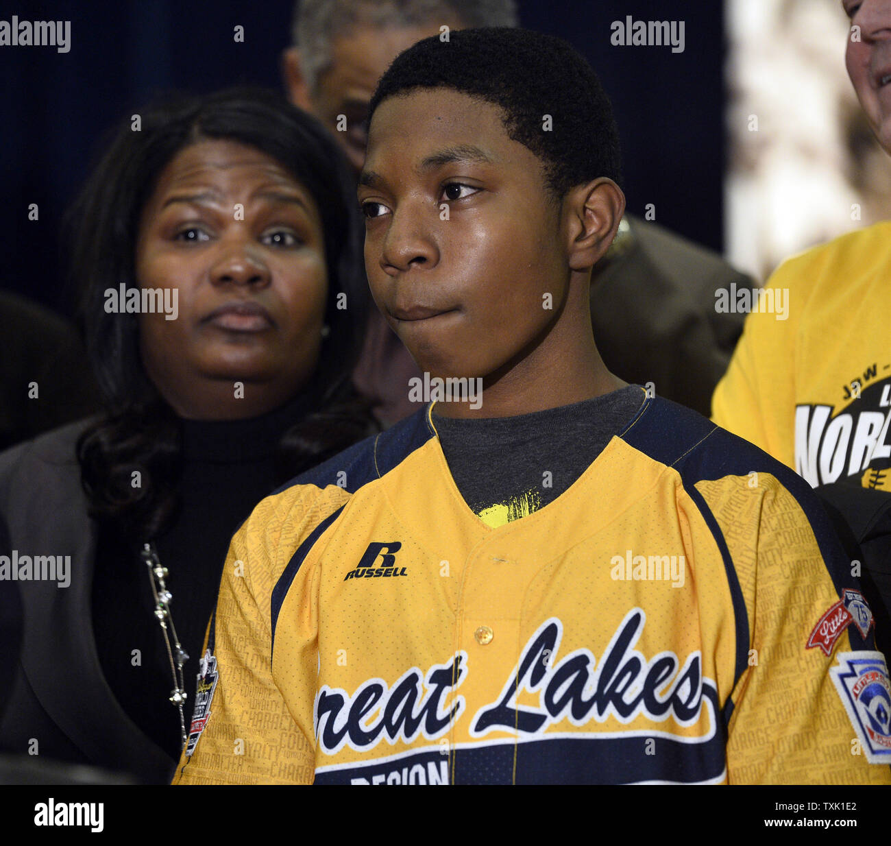 Jackie Robinson West little leaguer Brandon Green (R) stands with his mother Venisa at his side during a news conference at Operation Push Headquarters on February 11, 2015 in Chicago. Little League Baseball announced Wednesday that Jackie Robinson West used a falsified boundary map to claim players from other districts and must vacate wins from the 2014 Little League Baseball International Tournament, including its Great Lakes Regional and United States championships. Rev. Jesse Jackson and Rev. Michael Pfleger alleged that Jackie Robinson West faced unequal scrutiny as the only all-African A Stock Photo