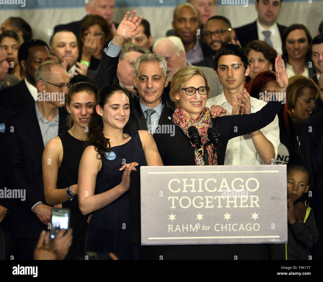 Chicago Mayor Rahm Emanuel (C) waves to supporters as he stands on stage with his wife Amy Rule, son Zachariah (R) and daughters Leah and Ilana at a rally at the Plumbers Local Union 130 hall following the mayoral run-off election in Chicago on April 7, 2015. Emanuel defeated opponent Jesus 'Chuy' Garcia in the first runoff since Chicago switched to non-partisan elections 20 years ago.       Photo by Brian Kersey/UPI Stock Photo