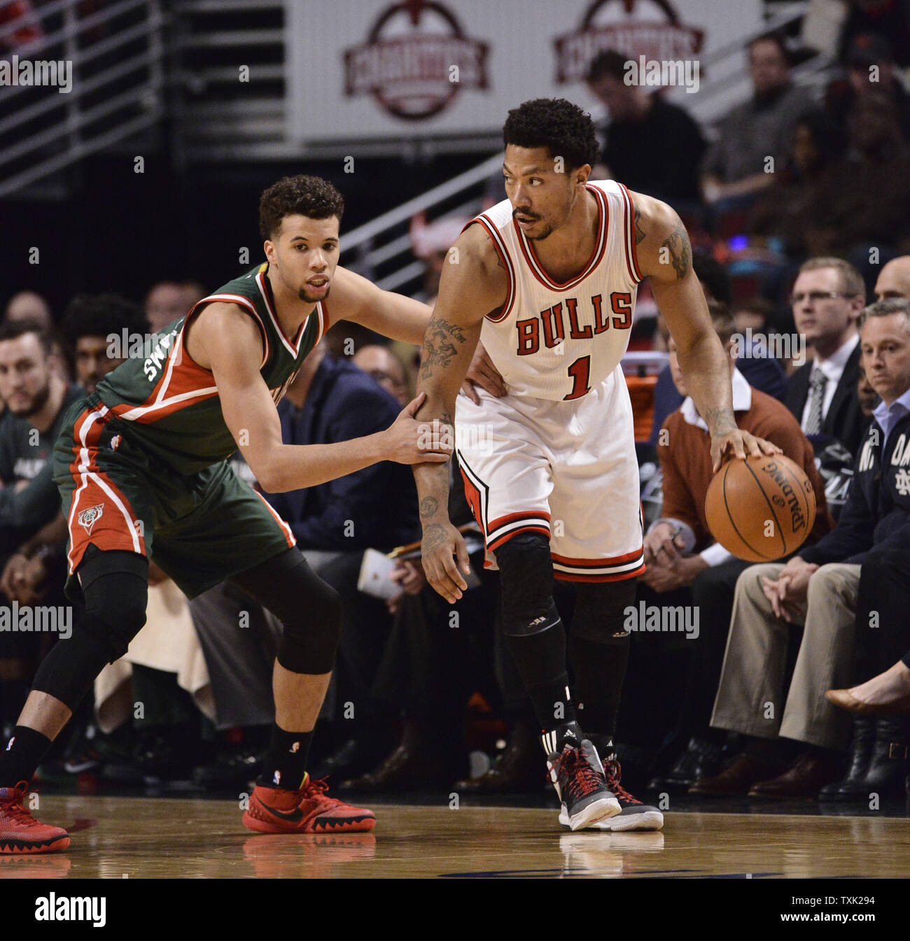 Chicago Bulls guard Derrick Rose (R) moves the ball as Milwaukee Bucks  guard Michael Carter-Williams defends during the third quarter of game 2  the first round of the NBA Playoffs at the