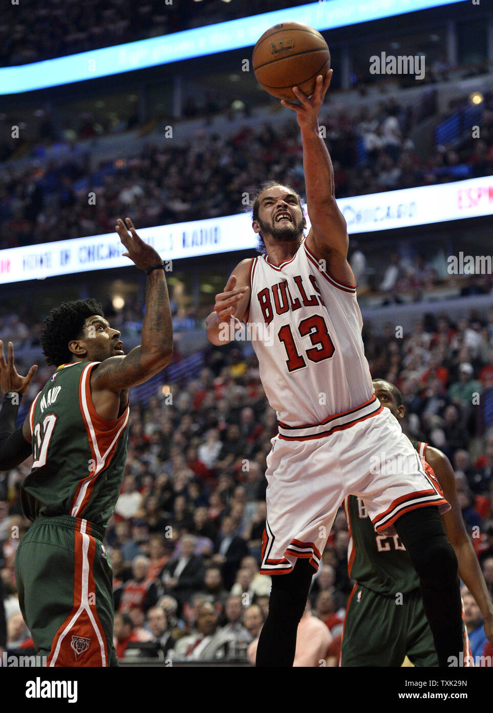 Chicago Bulls center Joakim Noah (R) drives the the basket past Milwaukee Bucks guard O.J. Mayo during the second quarter of game 2 the first round of the NBA Playoffs at the United Center on April 20, 2015 in Chicago. The Bulls defeated the Bucks 91-82 and lead the best of seven series 2-0.     Photo by Brian Kersey/UPI Stock Photo