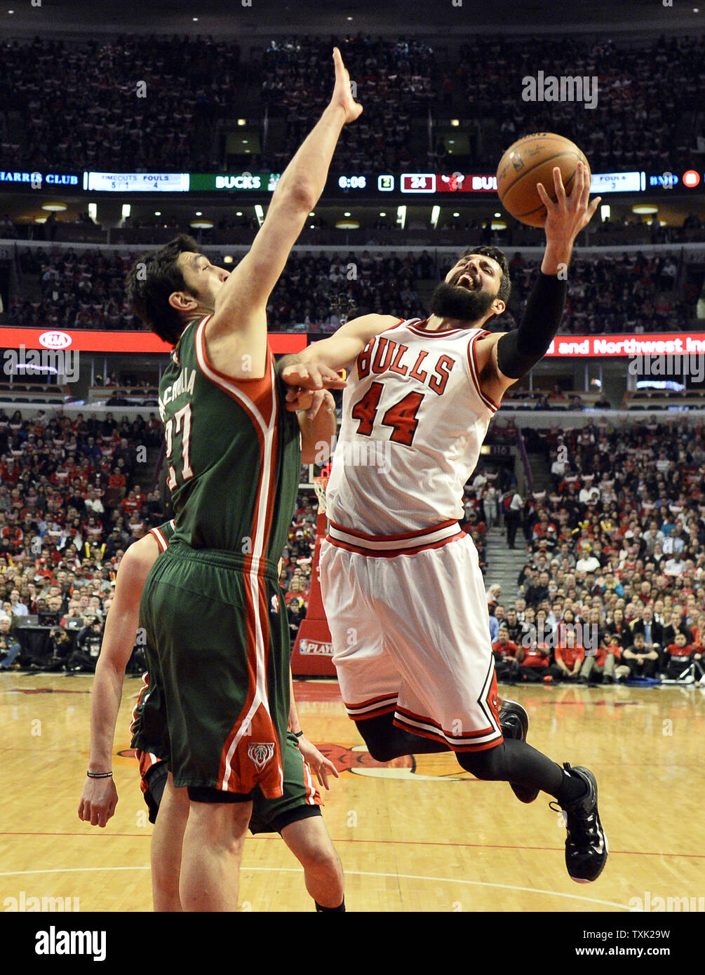 Chicago Bulls forward Nikola Mirotic (R) drives to the basket as Milwaukee Bucks center Zaza Pachulia defends during the second quarter of game 2 the first round of the NBA Playoffs at the United Center on April 20, 2015 in Chicago. The Bulls defeated the Bucks 91-82 and lead the best of seven series 2-0.     Photo by Brian Kersey/UPI Stock Photo