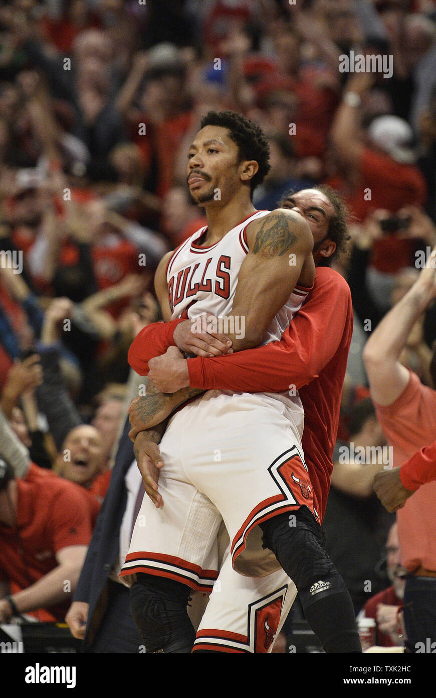 Chicago Bulls center Joakim Noah (R) hugs guard Derrick Rose after Rose hit  a last second three-point shot to defeat the Cleveland Cavaliers after game  3 of the Eastern Conference Semifinals of
