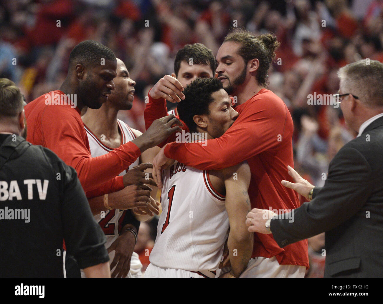 Chicago Bulls guard Derrick Rose (C) is hugged by center Joakim Noah (R), center Nazr Mohammed and the rest of his teammates after sinking a game-winning, three-point shot during the fourth quarter of game 3 the Eastern Conference Semifinals of the NBA Playoffs against the Cleveland Cavaliers at the United Center on May 8, 2015 in Chicago. The Bulls defeated the Cavaliers 99-96 and lead the best of seven series 2-1.     Photo by Brian Kersey/UPI Stock Photo