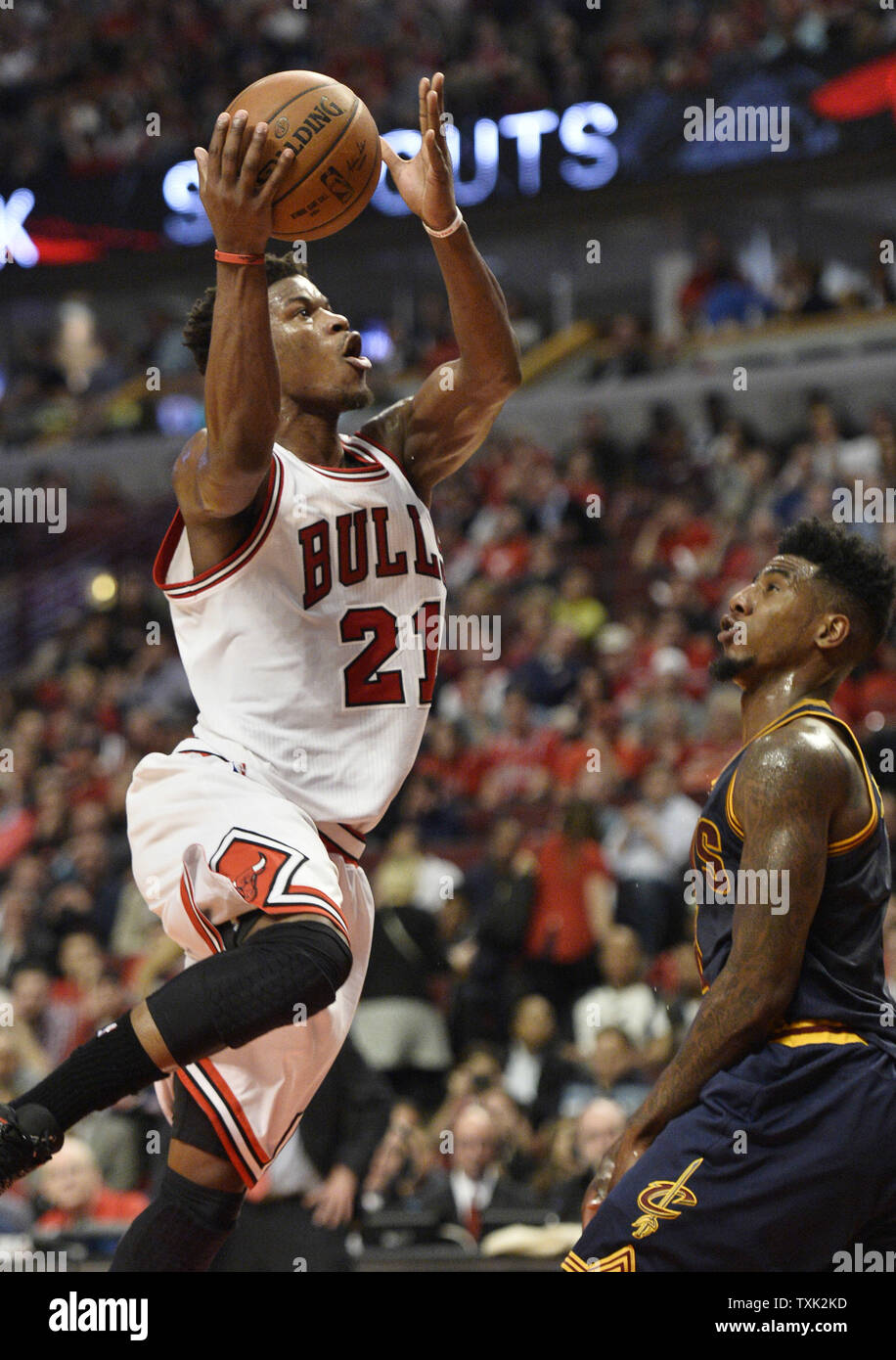 Jimmy Butler Guarding Chicago Bulls guard Jimmy Butler (L) shoots as Cleveland Cavaliers ...