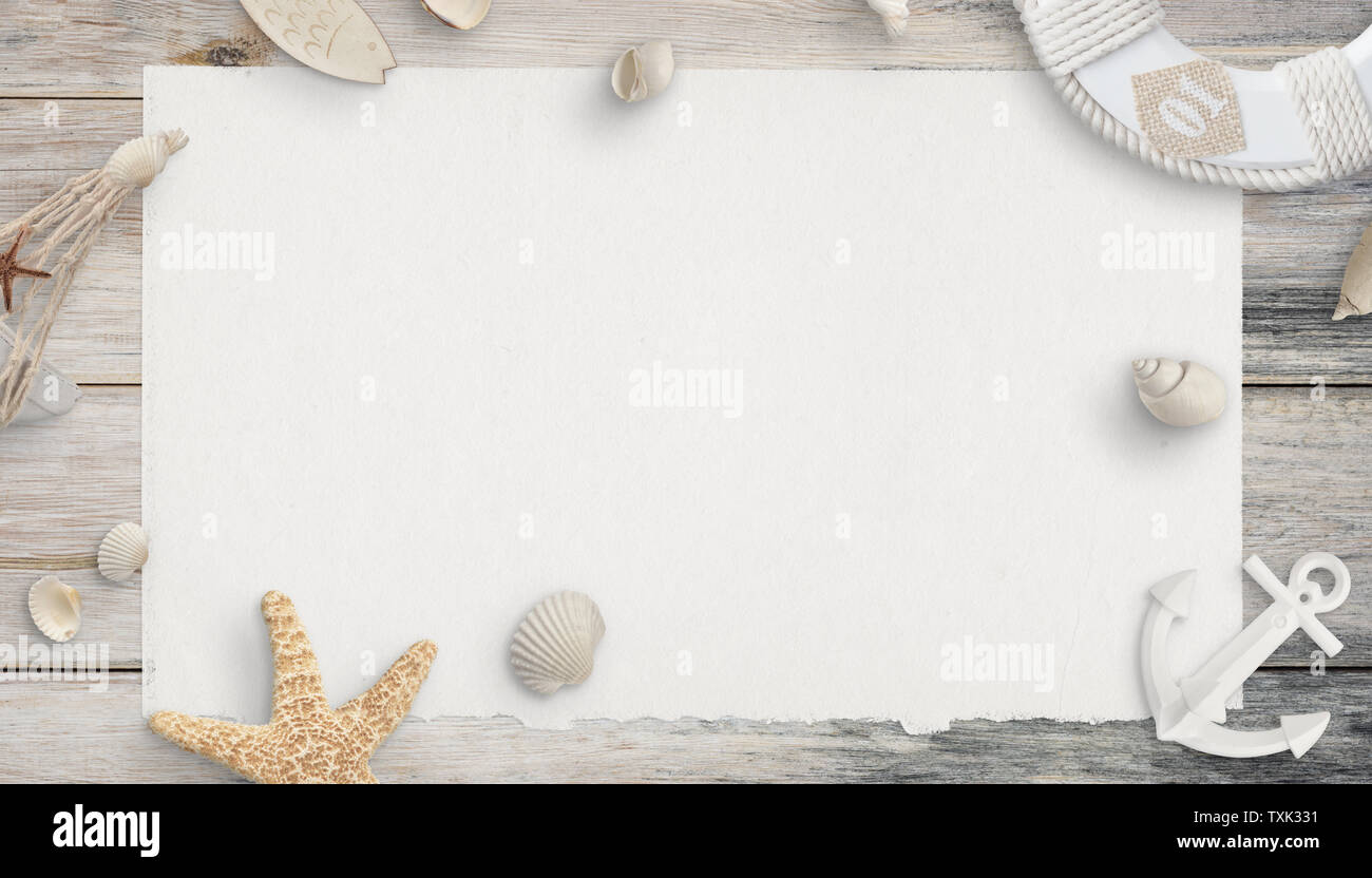 Empty paper surrounded by shells and sea things. Top view, flat lay composition on wooden table. Stock Photo