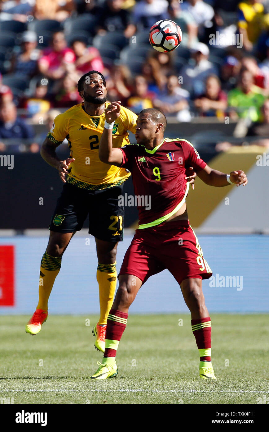 Jamaica defender Damano Solomon (L) and Venezuela forward Jose Salomon  Rondon go for the ball during the first half of a 2016 Copa America  Centenario Group C match at Soldier Field in