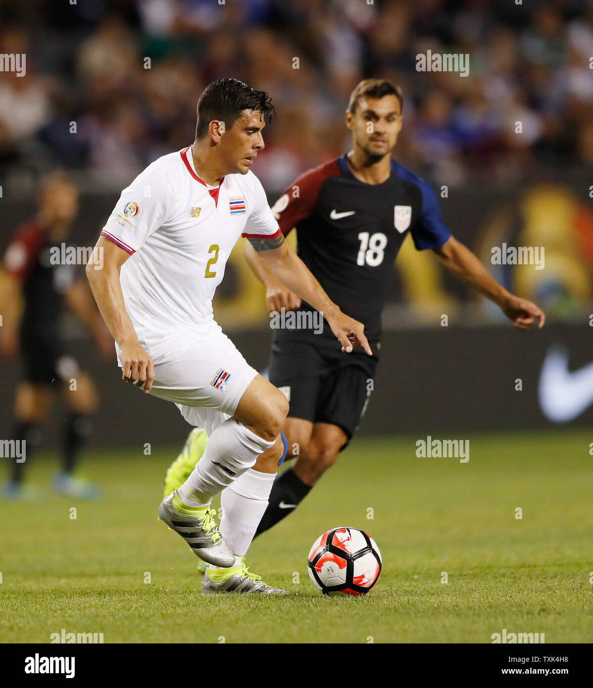 Costa Rica defender Johnny Acosta (L) moves the ball as United States forward Chris Wondolowski defends during the first half of a 2016 Copa America Centenario Group A match at Soldier Field in Chicago on June 7, 2016. The United States defeated Costa Rica 4-0.     Photo by Brian Kersey/UPI Stock Photo