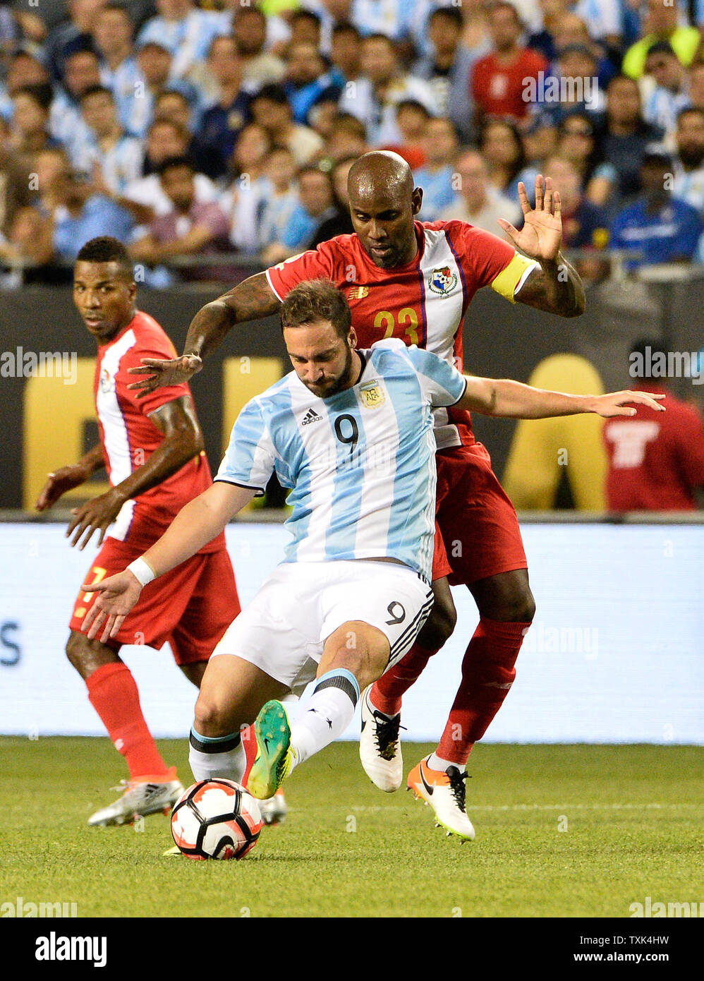 Argentina forward Gonzalo Higuain (L) kicks the ball as Panama defender Felipe Baloy defends during the first half of a 2016 Copa America Centenario Group D match at Soldier Field in Chicago on June 10, 2016. Argentina defeated Panama 5-0.     Photo by Brian Kersey/UPI Stock Photo
