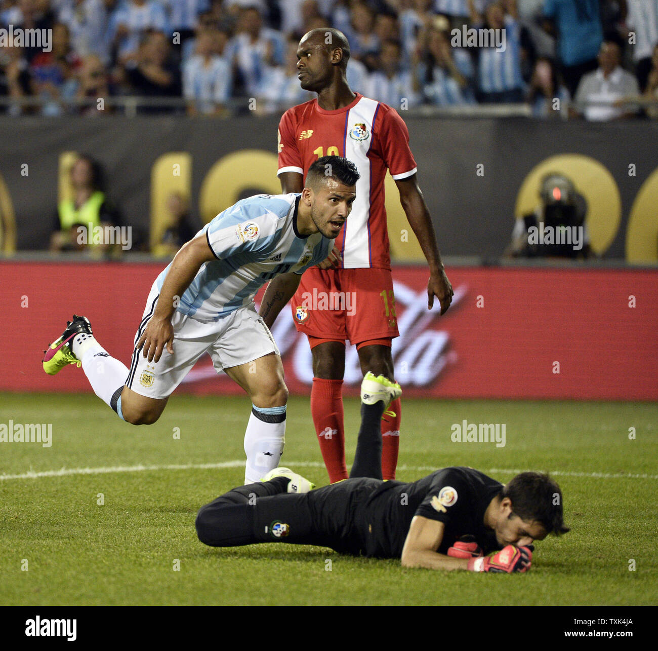 Argentina forward Sergio Aguero (L) reacts after scoring on a header past Panama goalkeeper Jaime Penedo (R) and defender Adolfo Machado  during the second half of a 2016 Copa America Centenario Group D match at Soldier Field in Chicago on June 10, 2016. Argentina defeated Panama 5-0.     Photo by Brian Kersey/UPI Stock Photo