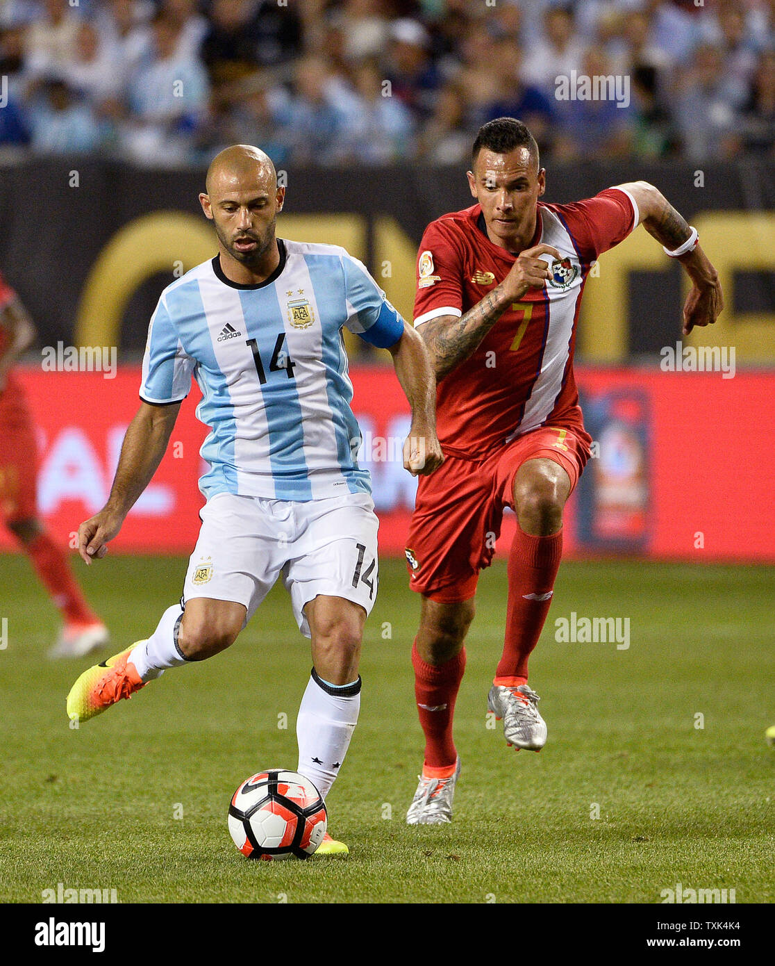 Argentina midfielder Javier Mascherano moves the ball as Panama forward Blas Perez chases him during the first half of a 2016 Copa America Centenario Group D match at Soldier Field in Chicago on June 10, 2016. Argentina defeated Panama 5-0.     Photo by Brian Kersey/UPI Stock Photo