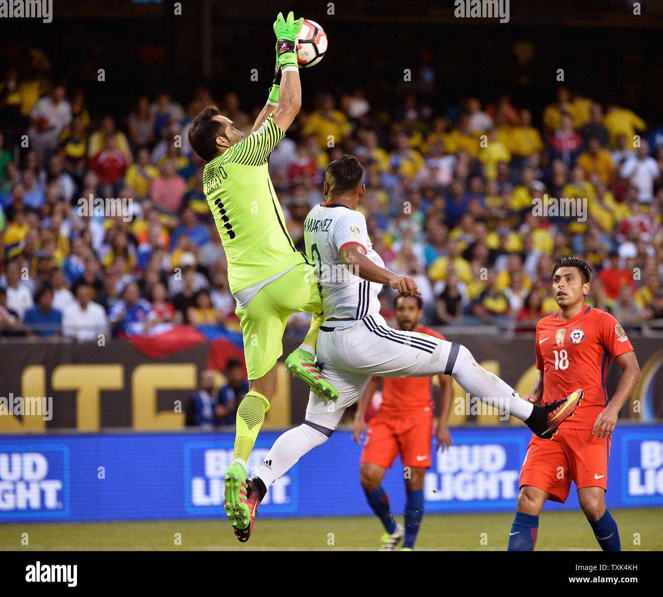 Chile goalkeeper Claudio Bravo makes a save as Colombia forward Roger Martinez tries to get to the ball during the first half of a 2016 Copa America Centenario Semifinal match at Soldier Field in Chicago on June 22, 2016.     Photo by Brian Kersey/UPI Stock Photo