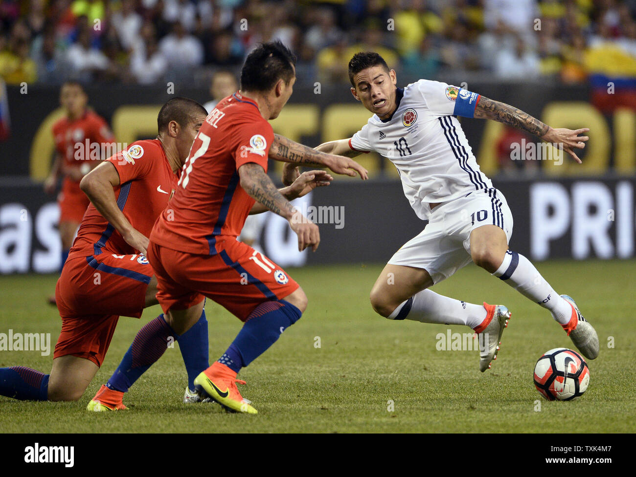 Colombia midfielder James Rodriguez (R) makes a move as Chile midfielder Francisco Silva (L) and defender Gary Medel defend during the first half of a 2016 Copa America Centenario Semifinal match at Soldier Field in Chicago on June 22, 2016.     Photo by Brian Kersey/UPI Stock Photo