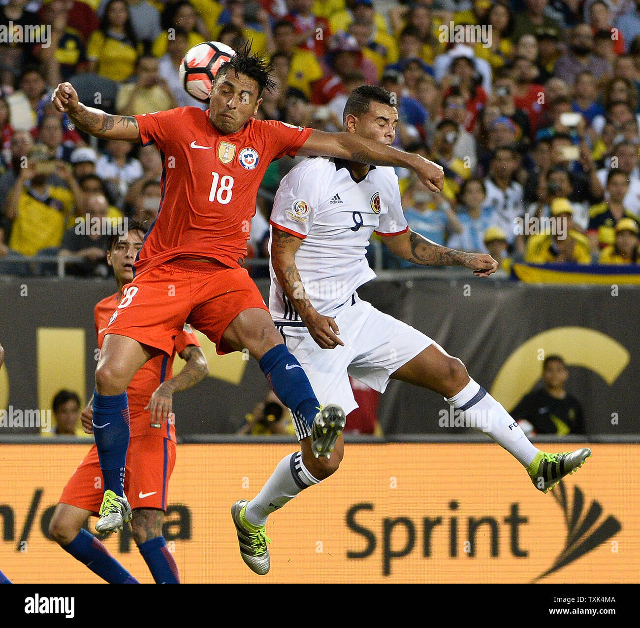 Chile defender Gonzalo Jara (L) and Colombia forward Roger Martinez go for a header during the first half of a 2016 Copa America Centenario Semifinal match at Soldier Field in Chicago on June 22, 2016.     Photo by Brian Kersey/UPI Stock Photo