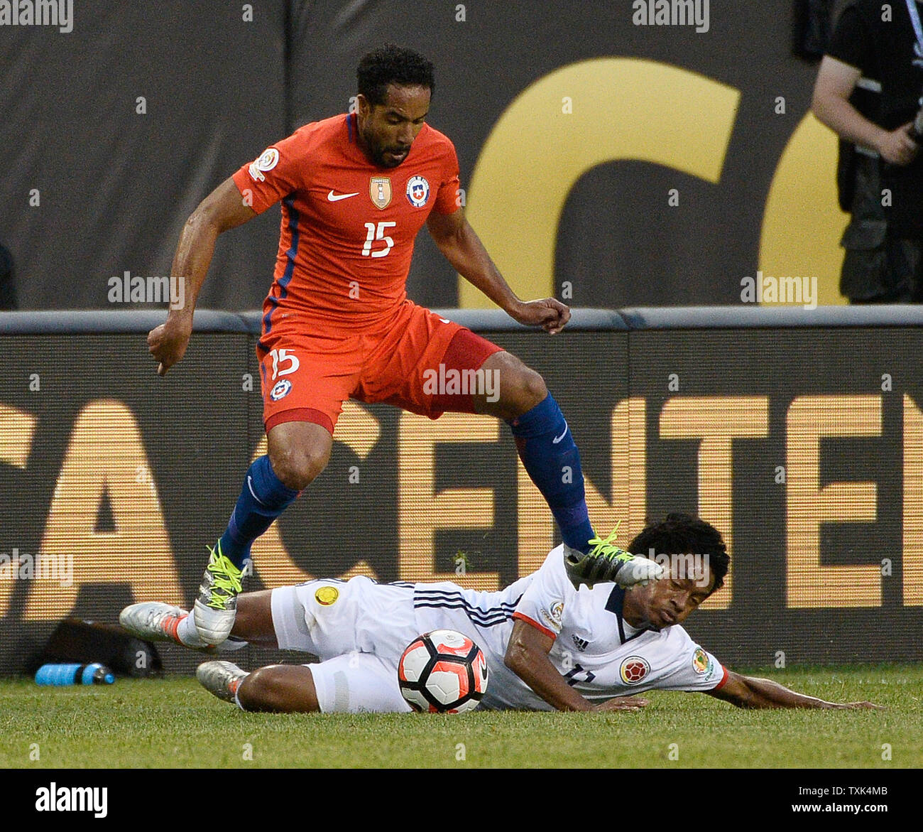 Chile midfielder Jean Beausejour (L) and Colombia midfielder Juan Cuadrado go for the ball during the first half of a 2016 Copa America Centenario Semifinal match at Soldier Field in Chicago on June 22, 2016.     Photo by Brian Kersey/UPI Stock Photo