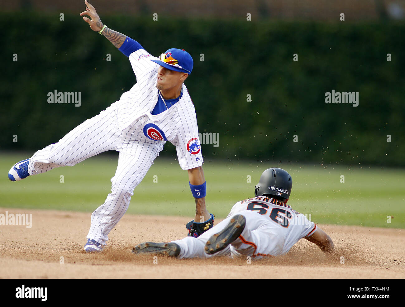 Chicago Cubs shortstop Javier Baez (L) tags out San Francisco Giants Gorkys Hernandez on a steal attempt of second base in the 12th inning of their game on September 4, 2016 in Chicago. The Cubs defeated the Giants 3-2 in 13 innings. Photo by Frank Polich/UPI Stock Photo
