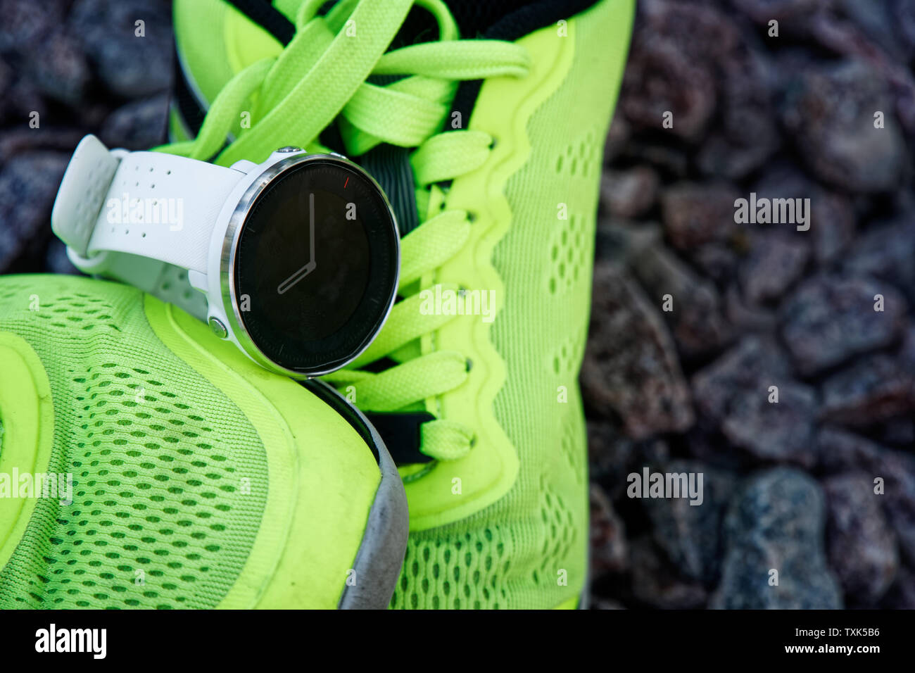 Sport watch for crossfit and triathlon on the green running shoes. Smart  watch for tracking daily activity and strength training Stock Photo - Alamy